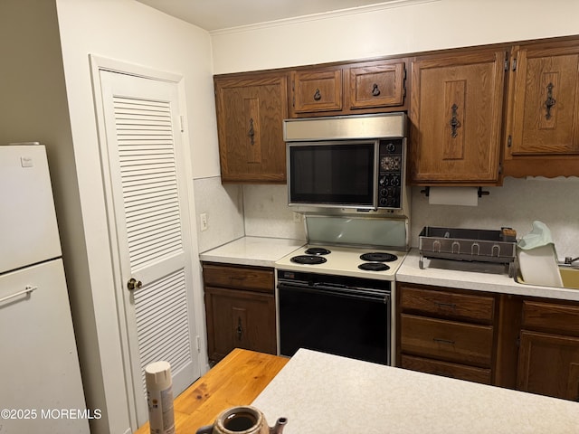 170 E Holly Ln Unit 105, Little Egg Harbor, NJ 08087 - kitchen with stainless steel microwave, white electric stove, and light countertops