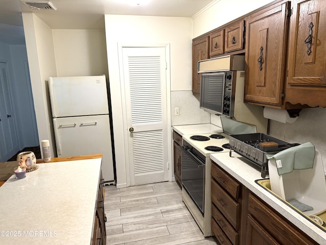 170 E Holly Ln Unit 105, Little Egg Harbor, NJ 08087 - kitchen featuring white appliances, light countertops, and light wood-style floors
