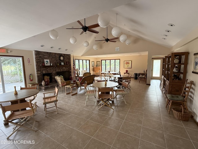 170 E Holly Ln Unit 105, Little Egg Harbor, NJ 08087 - dining area with dark tile patterned floors, a fireplace, high vaulted ceiling, beamed ceiling, and a ceiling fan
