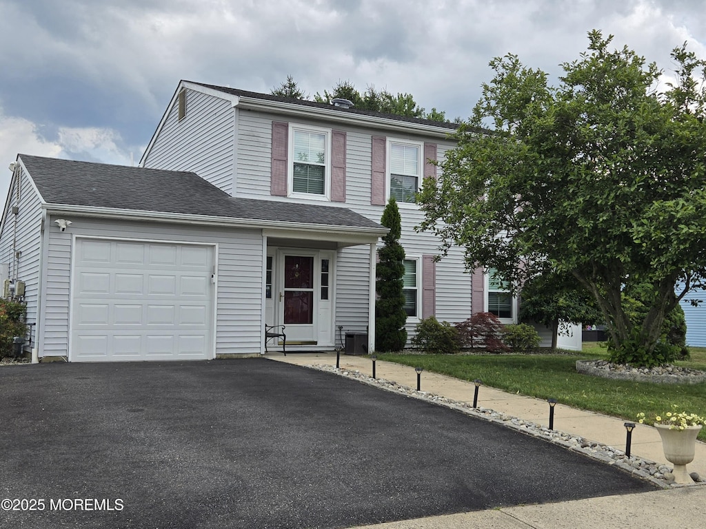 33 Snowdrift Ln, Howell, NJ 07731 - traditional home with an attached garage and asphalt driveway