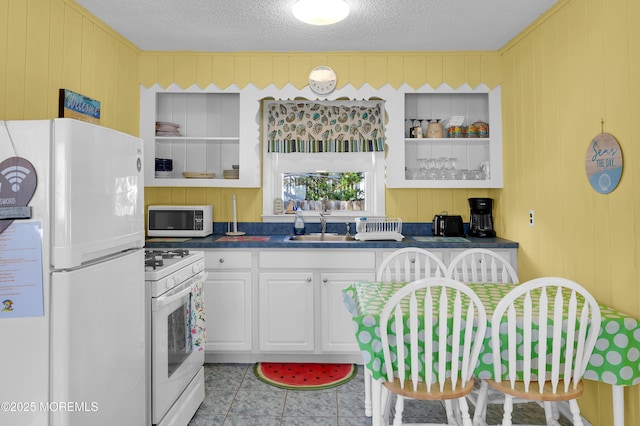 19 Elizabeth Ave, Lavallette, NJ 08735 - kitchen featuring white appliances, dark countertops, a textured ceiling, white cabinets, and open shelves