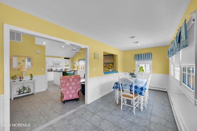 19 Elizabeth Ave, Lavallette, NJ 08735 - dining room with baseboard heating, a wainscoted wall, light tile patterned floors, recessed lighting, and a ceiling fan