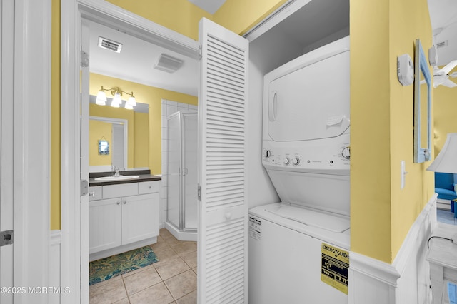 19 Elizabeth Ave, Lavallette, NJ 08735 - laundry room with stacked washer and clothes dryer and light tile patterned flooring