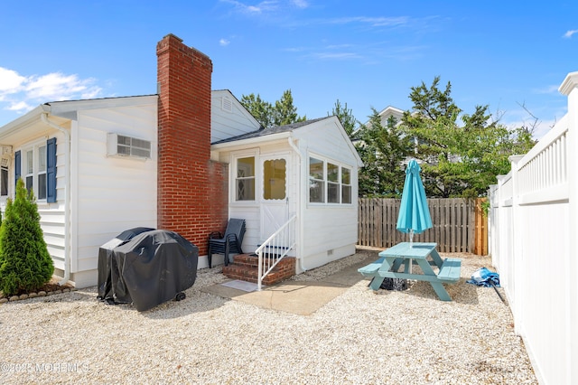 19 Elizabeth Ave, Lavallette, NJ 08735 - back of house with a chimney, a fenced backyard, crawl space, entry steps, and an AC wall unit
