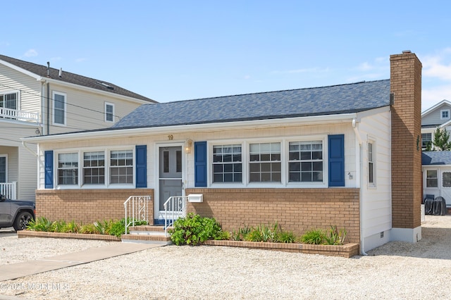 19 Elizabeth Ave, Lavallette, NJ 08735 - view of front of property featuring brick siding, a chimney, and roof with shingles