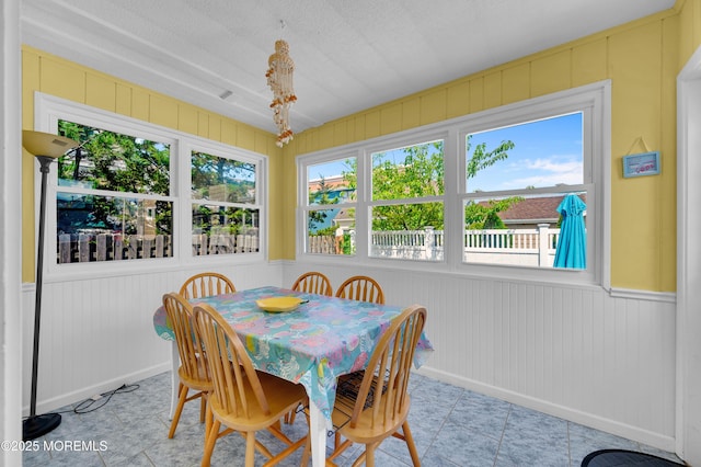 19 Elizabeth Ave, Lavallette, NJ 08735 - tiled dining area featuring wooden walls and a decorative wall