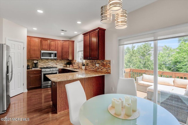 108 Warbler Way, Freehold, NJ 07728 - kitchen with stainless steel appliances, plenty of natural light, wood finished floors, backsplash, and recessed lighting