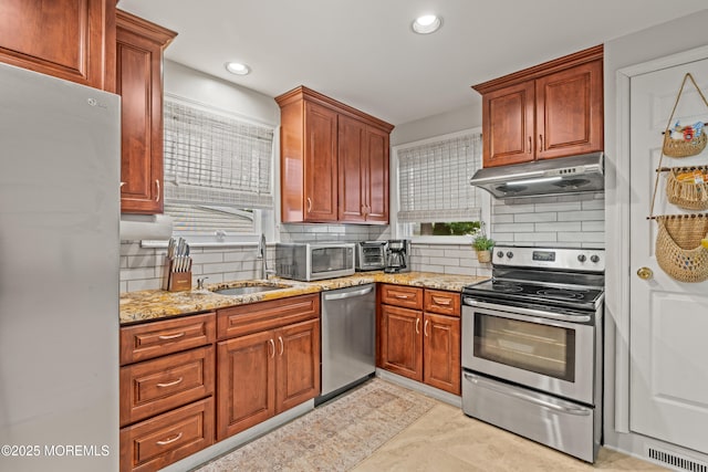15 Park Blvd, Ocean Twp, NJ 07712 - kitchen featuring appliances with stainless steel finishes, under cabinet range hood, tasteful backsplash, light stone countertops, and recessed lighting