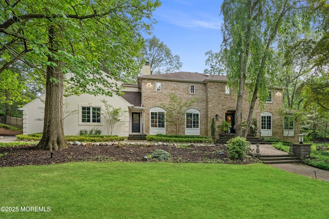 79 Cypress Neck Rd, Lincroft, NJ 07738 - colonial house featuring a front lawn, a chimney, and brick siding