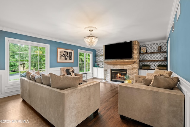 79 Cypress Neck Rd, Lincroft, NJ 07738 - living area with ornamental molding, a brick fireplace, wainscoting, dark wood-style flooring, and a chandelier