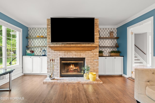 79 Cypress Neck Rd, Lincroft, NJ 07738 - unfurnished living room with wood finished floors, crown molding, stairs, and a fireplace