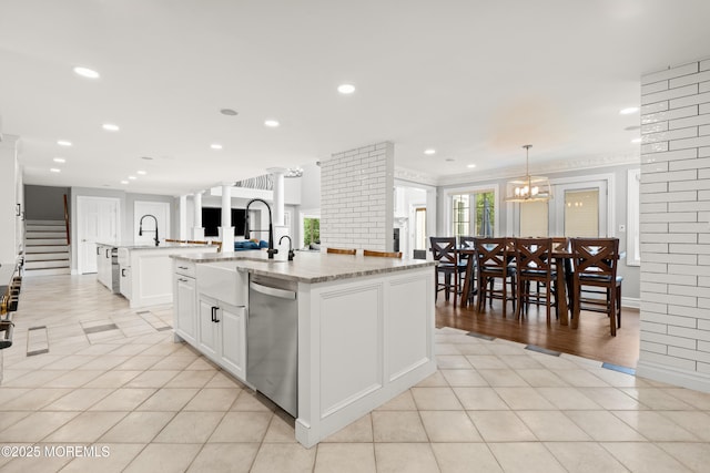 79 Cypress Neck Rd, Lincroft, NJ 07738 - kitchen featuring dishwasher, a large island, white cabinetry, light tile patterned flooring, and light stone counters