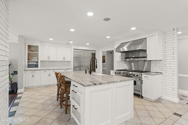 79 Cypress Neck Rd, Lincroft, NJ 07738 - kitchen featuring high quality appliances, wall chimney exhaust hood, backsplash, light tile patterned flooring, and recessed lighting