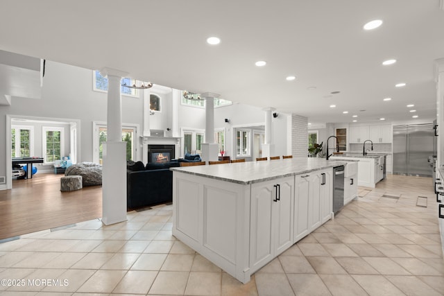 79 Cypress Neck Rd, Lincroft, NJ 07738 - kitchen with decorative columns, open floor plan, a spacious island, white cabinets, and recessed lighting