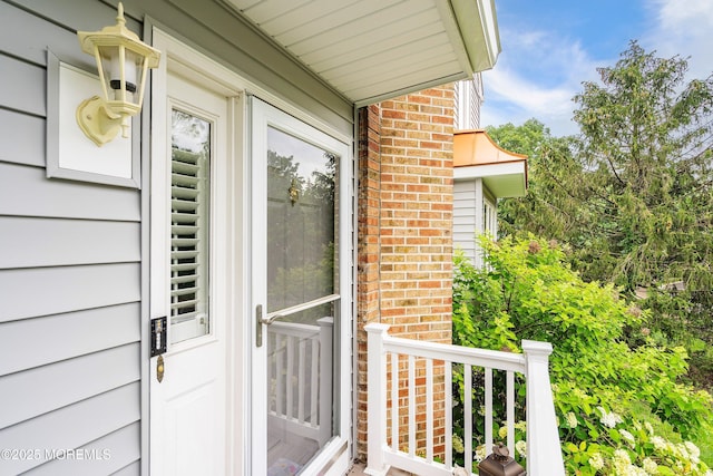 56 Violet Ct, Toms River, NJ 08753 - view of exterior entry featuring brick siding