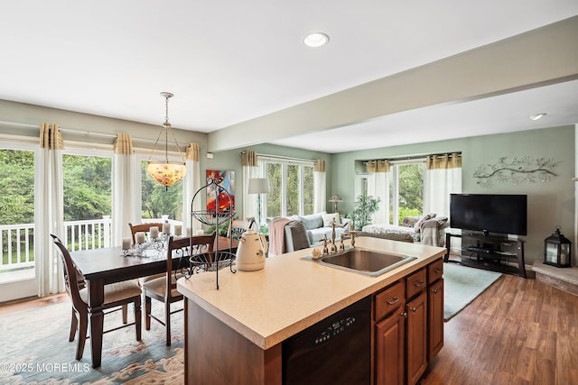 56 Violet Ct, Toms River, NJ 08753 - kitchen with black dishwasher, open floor plan, wood finished floors, light countertops, and a center island with sink