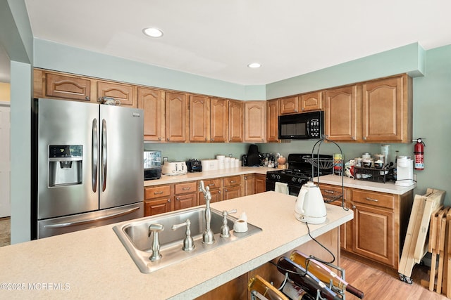 56 Violet Ct, Toms River, NJ 08753 - kitchen with black appliances, light countertops, recessed lighting, light wood finished floors, and brown cabinetry