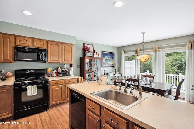 56 Violet Ct, Toms River, NJ 08753 - kitchen with black appliances, light countertops, brown cabinets, and recessed lighting