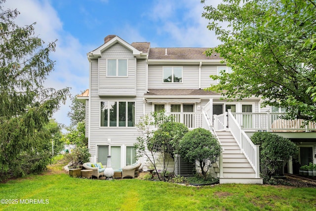 56 Violet Ct, Toms River, NJ 08753 - view of front of house with stairs, a chimney, a deck, a front lawn, and a shingled roof