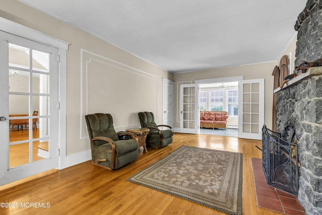 28 Broadway Rd, Freehold, NJ 07728 - sitting room with wood finished floors, a stone fireplace, and baseboard heating