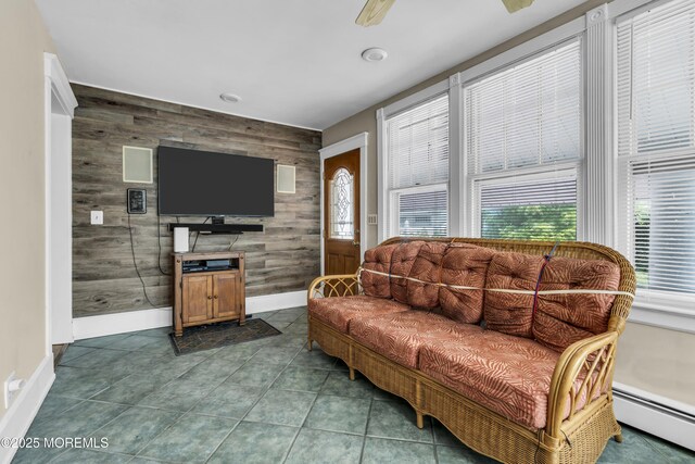 28 Broadway Rd, Freehold, NJ 07728 - living area featuring an accent wall, baseboard heating, wood walls, and dark tile patterned floors