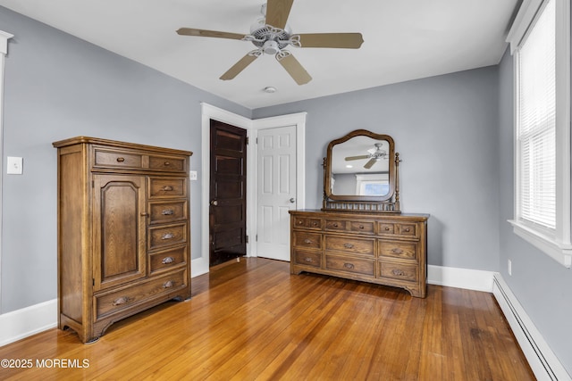 28 Broadway Rd, Freehold, NJ 07728 - bedroom featuring baseboard heating, light wood finished floors, and a ceiling fan
