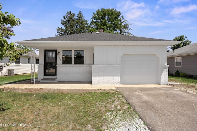 503 Jamaica Blvd, Toms River, NJ 08757 - view of front facade featuring brick siding, an attached garage, asphalt driveway, a shingled roof, and a chimney