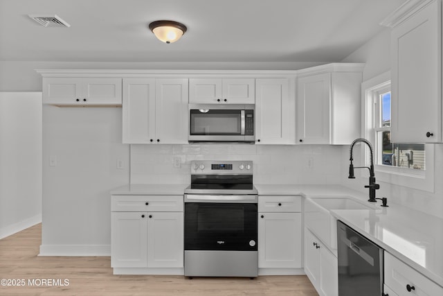 503 Jamaica Blvd, Toms River, NJ 08757 - kitchen featuring stainless steel appliances, white cabinets, and light countertops