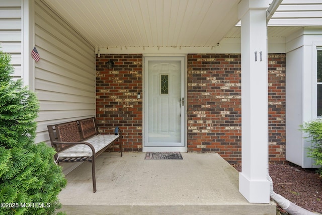 11 Hazelwood Ct, Howell, NJ 07731 - doorway to property featuring a porch and brick siding