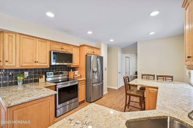 11 Hazelwood Ct, Howell, NJ 07731 - kitchen with appliances with stainless steel finishes, light wood-type flooring, light stone countertops, tasteful backsplash, and recessed lighting