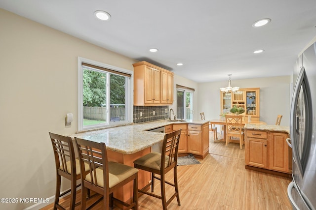 11 Hazelwood Ct, Howell, NJ 07731 - kitchen featuring a peninsula, freestanding refrigerator, tasteful backsplash, light wood-style floors, and recessed lighting