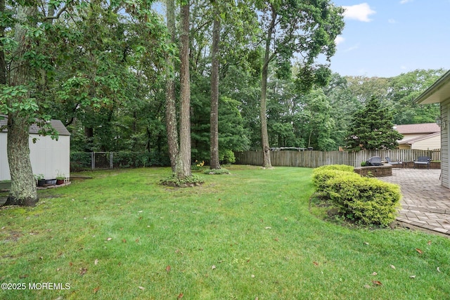 11 Hazelwood Ct, Howell, NJ 07731 - fenced backyard with a patio area, a storage shed, and a fire pit