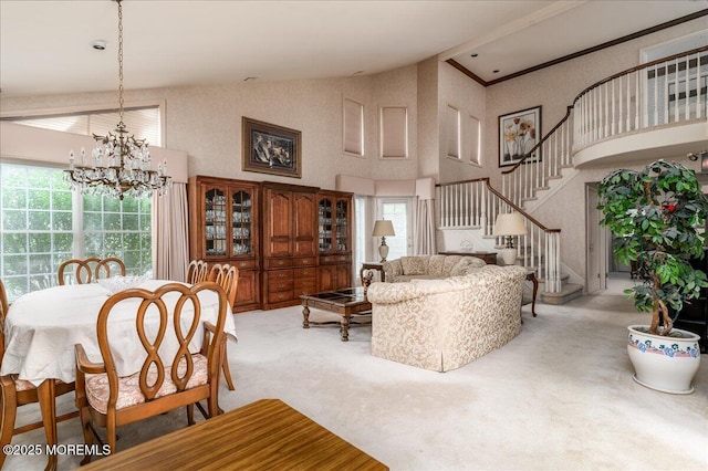 2331 Kira Ct, Toms River, NJ 08755 - carpeted living room with high vaulted ceiling, stairs, and a chandelier
