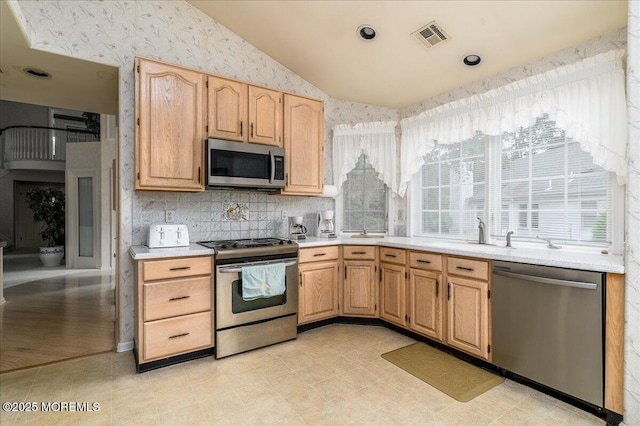 2331 Kira Ct, Toms River, NJ 08755 - kitchen featuring appliances with stainless steel finishes, lofted ceiling, light brown cabinetry, light countertops, and tasteful backsplash