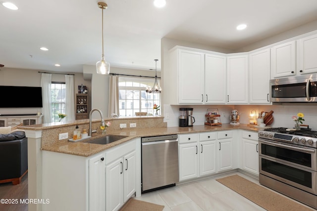 408 April Way, Middletown, NJ 07748 - kitchen with appliances with stainless steel finishes, a peninsula, open floor plan, tasteful backsplash, and white cabinets