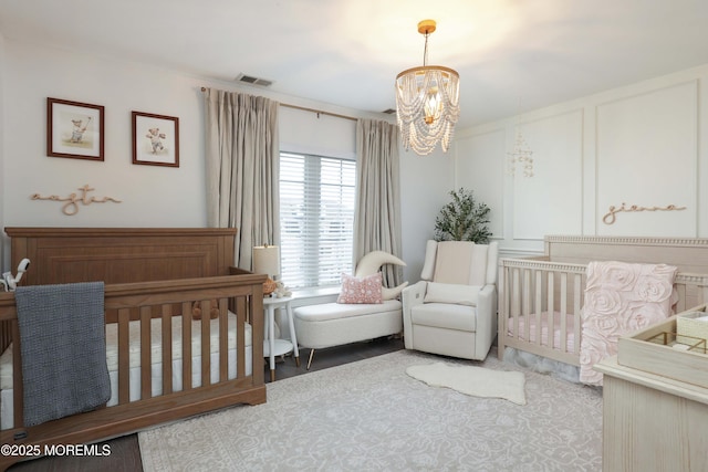 408 April Way, Middletown, NJ 07748 - bedroom with a chandelier and a crib