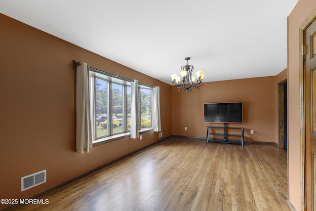 444 Pfister Rd, Jackson, NJ 08527 - unfurnished living room with a chandelier and light wood-style flooring