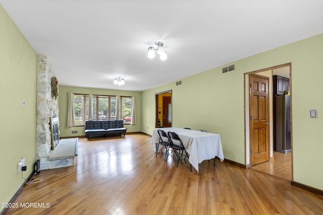 444 Pfister Rd, Jackson, NJ 08527 - dining room with light wood-style floors and a stone fireplace