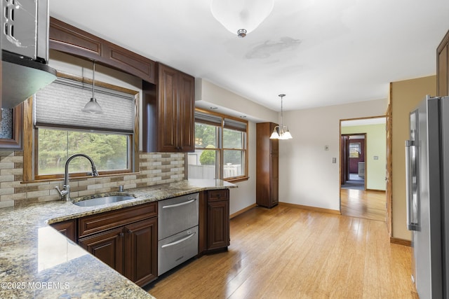 444 Pfister Rd, Jackson, NJ 08527 - kitchen with stainless steel appliances, decorative backsplash, light wood-style flooring, and decorative light fixtures