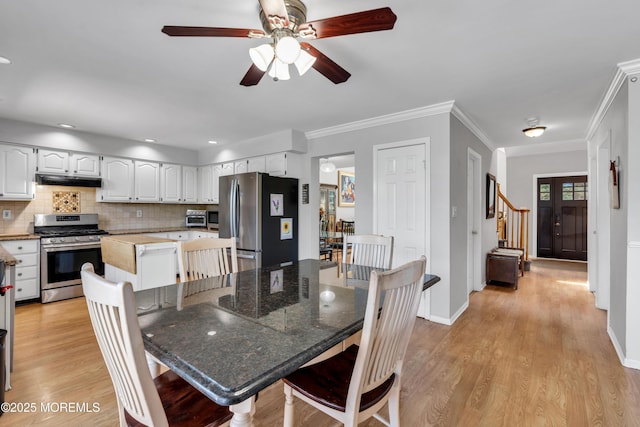 16 Arrowhead Way, Millstone, NJ 08535 - dining area featuring ceiling fan, light wood-type flooring, stairs, and crown molding