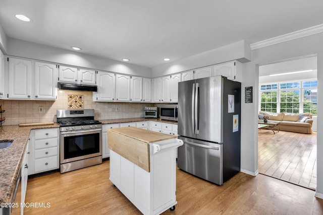 16 Arrowhead Way, Millstone, NJ 08535 - kitchen featuring appliances with stainless steel finishes, under cabinet range hood, tasteful backsplash, crown molding, and white cabinetry