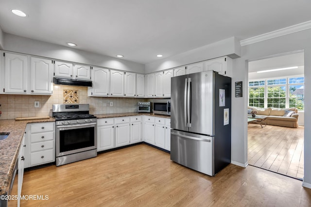 16 Arrowhead Way, Millstone, NJ 08535 - kitchen with stainless steel appliances, stone countertops, white cabinets, light wood-style flooring, and decorative backsplash