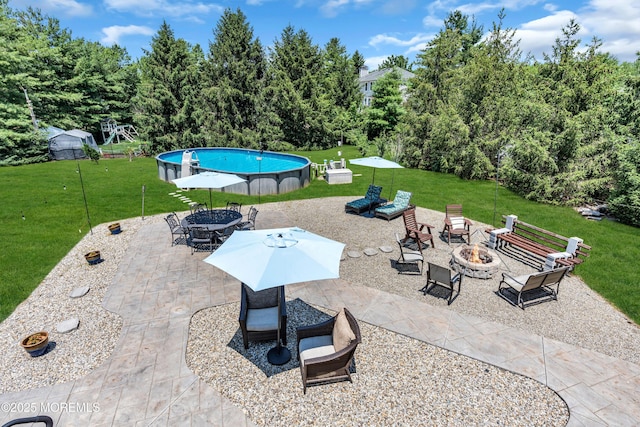 16 Arrowhead Way, Millstone, NJ 08535 - view of patio with an outdoor fire pit, an outdoor pool, and outdoor dining space
