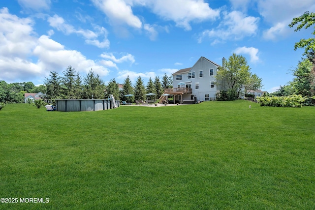 16 Arrowhead Way, Millstone, NJ 08535 - view of grassy yard featuring a wooden deck and an outdoor pool