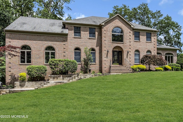 2 Shady Oak Ct, Millstone, NJ 08535 - colonial-style house with a front lawn, brick siding, and a shingled roof