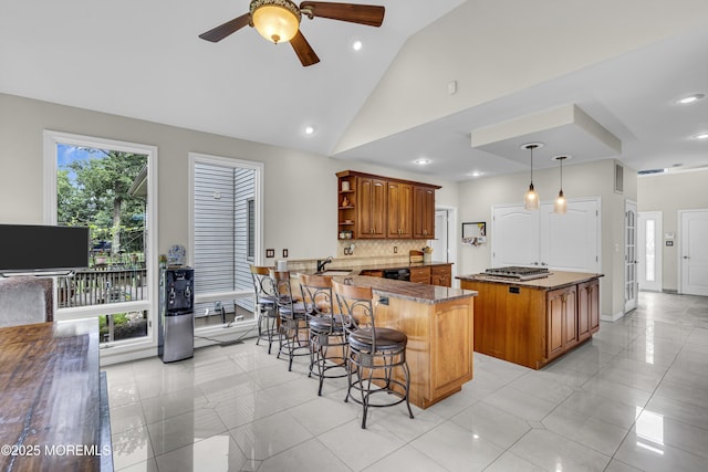 2 Shady Oak Ct, Millstone, NJ 08535 - kitchen featuring open shelves, ceiling fan, stainless steel gas stovetop, brown cabinets, and a peninsula
