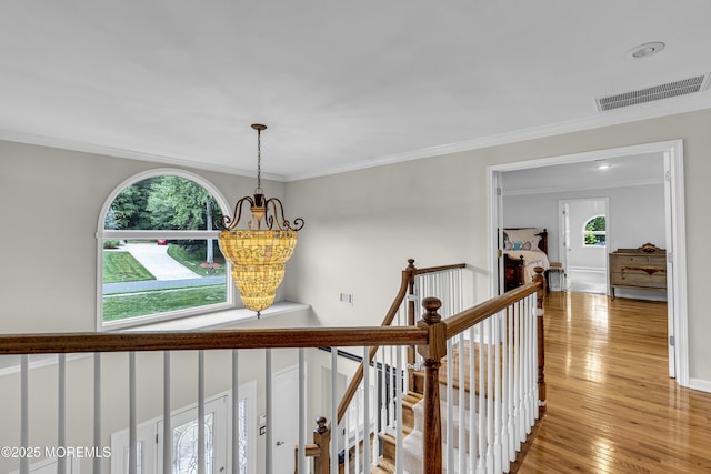 2 Shady Oak Ct, Millstone, NJ 08535 - hall with a chandelier, crown molding, light wood-type flooring, and an upstairs landing