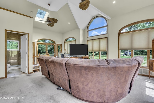 2 Shady Oak Ct, Millstone, NJ 08535 - living area with light colored carpet, a skylight, high vaulted ceiling, and healthy amount of natural light