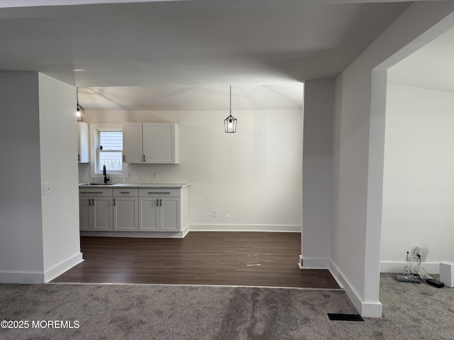 17 Mayfair Ct, Brick, NJ 08723 - kitchen with dark carpet, decorative light fixtures, dark wood finished floors, light countertops, and white cabinets