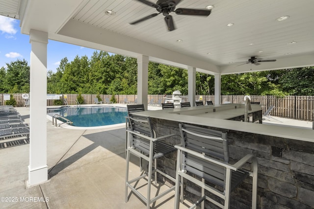 28202 Radford Ct, Monroe, NJ 08831 - fenced backyard featuring a ceiling fan, a community pool, view of wooded area, and a patio area